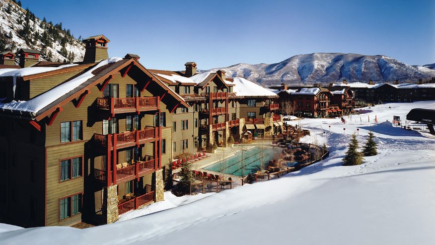 Resort in the mountains with an outdoor pool and snowy landscape