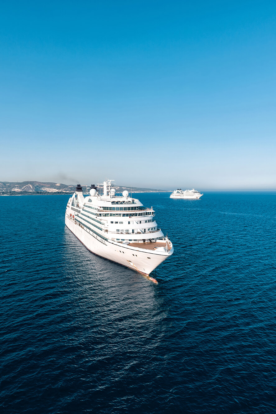 Cruise ship on the dark blue ocean with another cruise ship in the distance