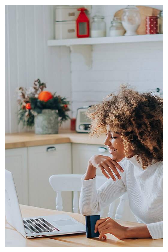 Woman sitting at a table working on her laptop