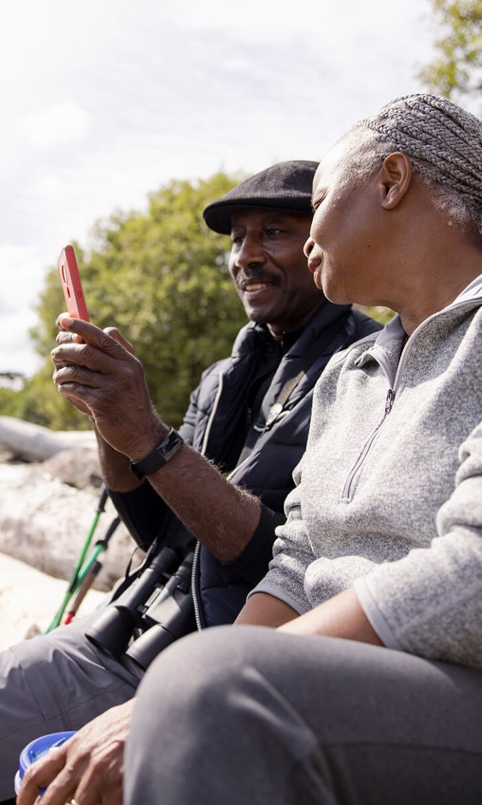 Couple looking at a mobile device together.